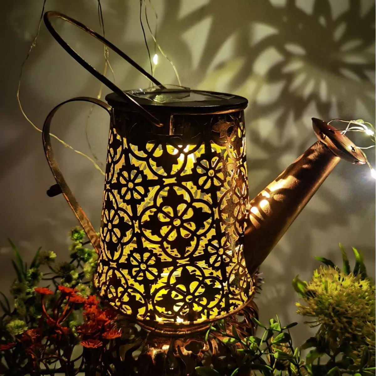 Solar-powered wrought iron butterfly kettle light for outdoor garden decoration.