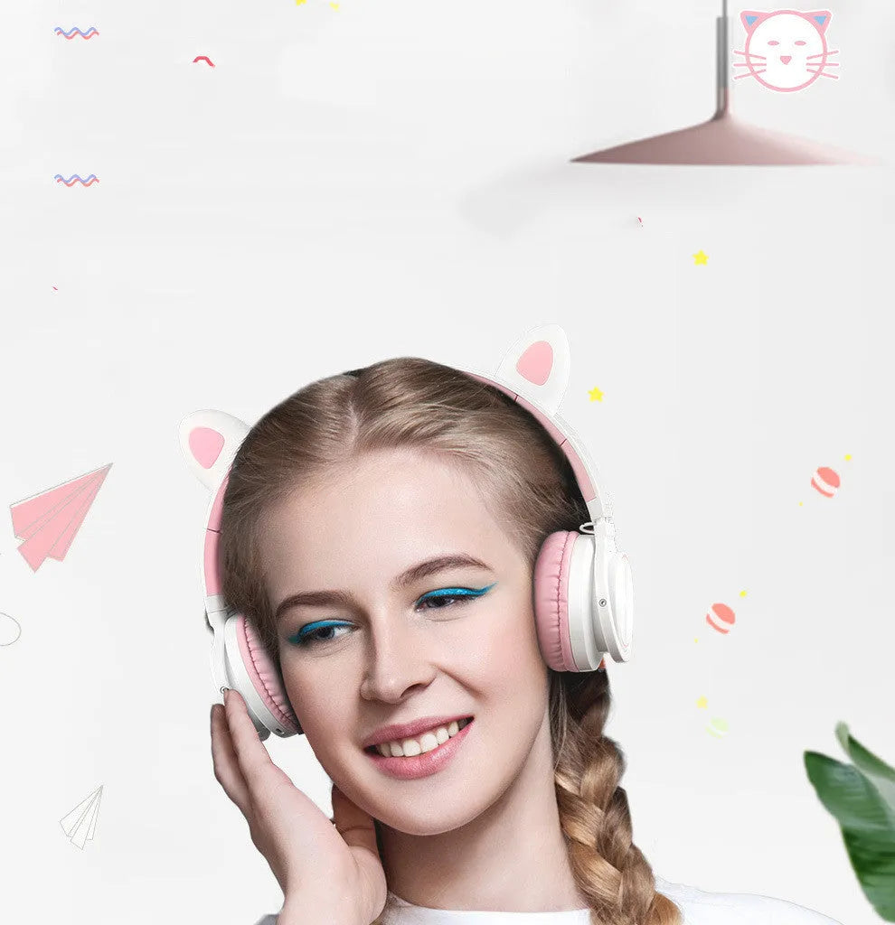 Pink white Luminous Bluetooth over-ear headphones showing protein ear cushions and braided cable.