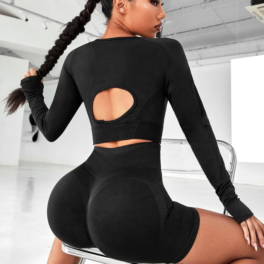 Women's high waist yoga suit in black, brown, or purple colours, showing pullover top and tight-fitting pants.