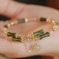 Women's plum wine coloured bamboo joint bracelet with adjustable beaded design