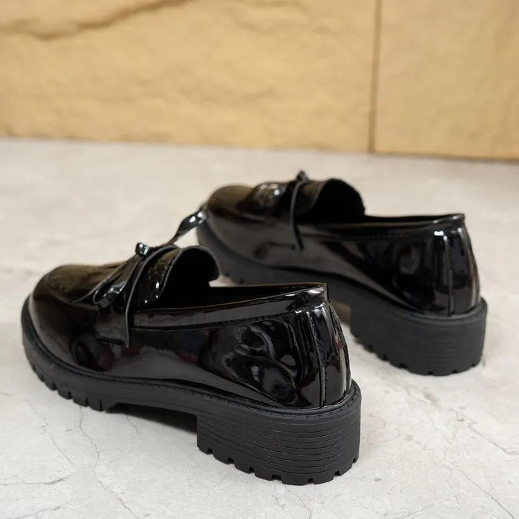 Women's brown loafer shoe with a decorative bow on the artificial PU upper.