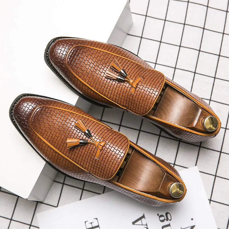 Men's black pointed slip-on shoes with a tassel detail on the front, made from artificial PU.