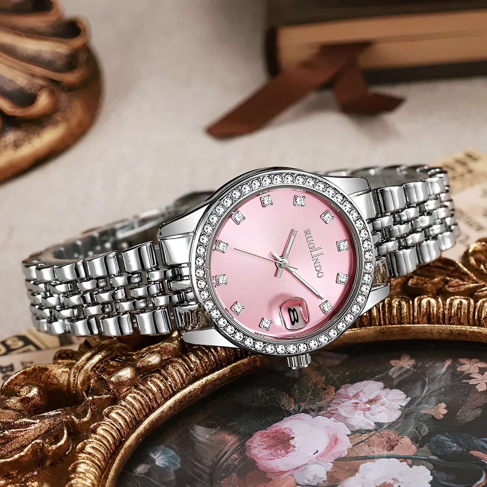 Women's silver calendar watch with 32mm dial, quartz movement, and stainless steel buckle.