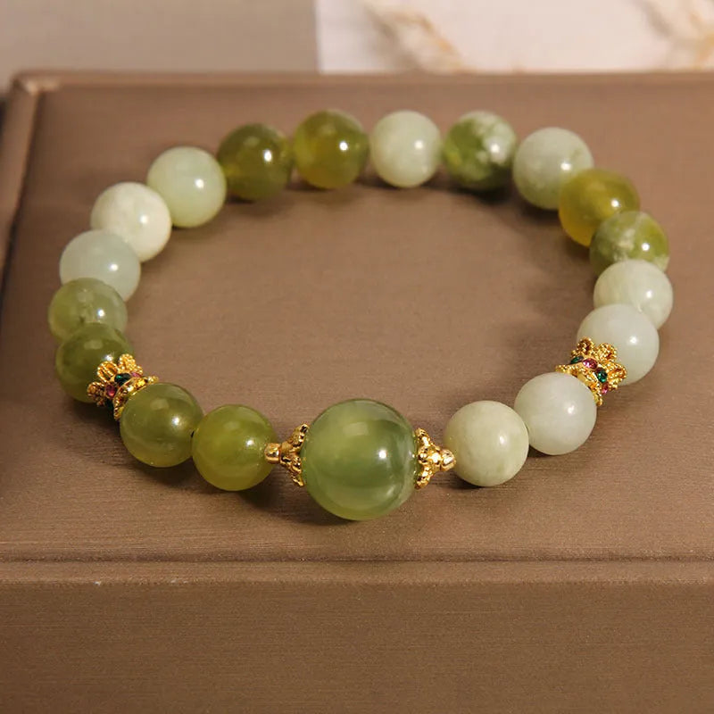 Original design women's bracelet with a single green Xiuyan jade stone in a Mori style.