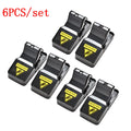 Six black plastic snapping mousetraps showing trigger mechanism and spring design