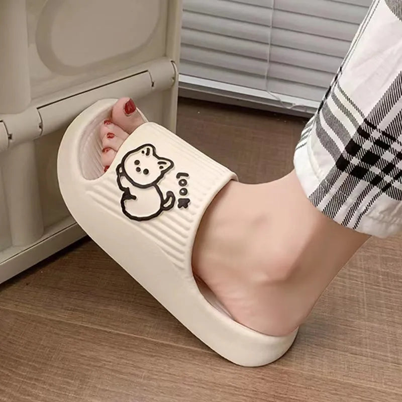 Women's cat platform slippers in pink with thick EVA sole, shown on a wooden floor.