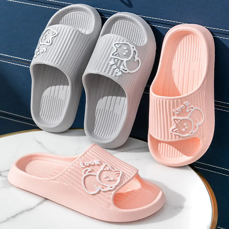 Women's cat platform slippers in pink with thick EVA sole, shown on a wooden floor.