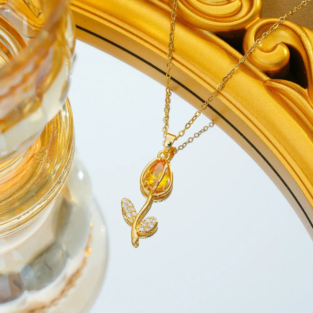 Zircon tulip pendant necklace for women in electroplated gold colours on an adjustable O-ring chain.