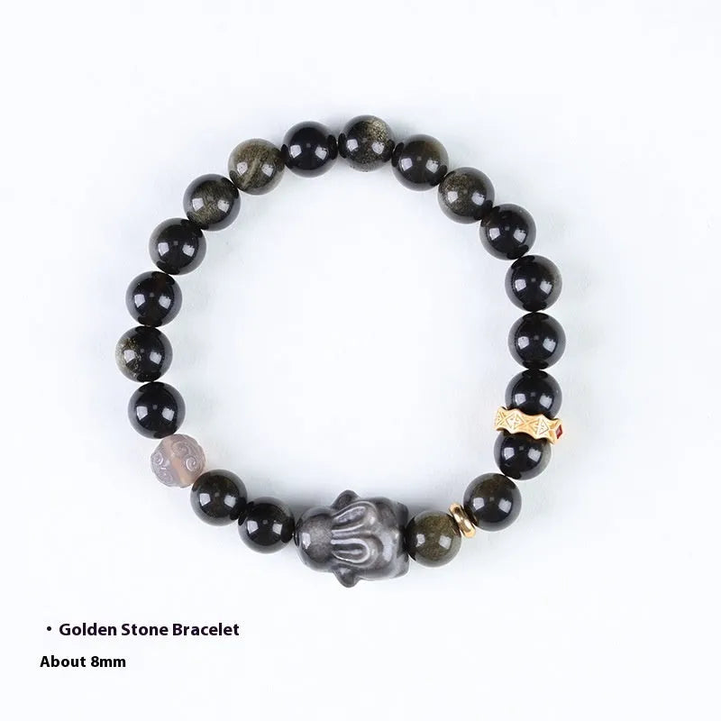 Handmade Chinese style bracelet with lying rabbit charm, grey agate bead, and brass on a black background.