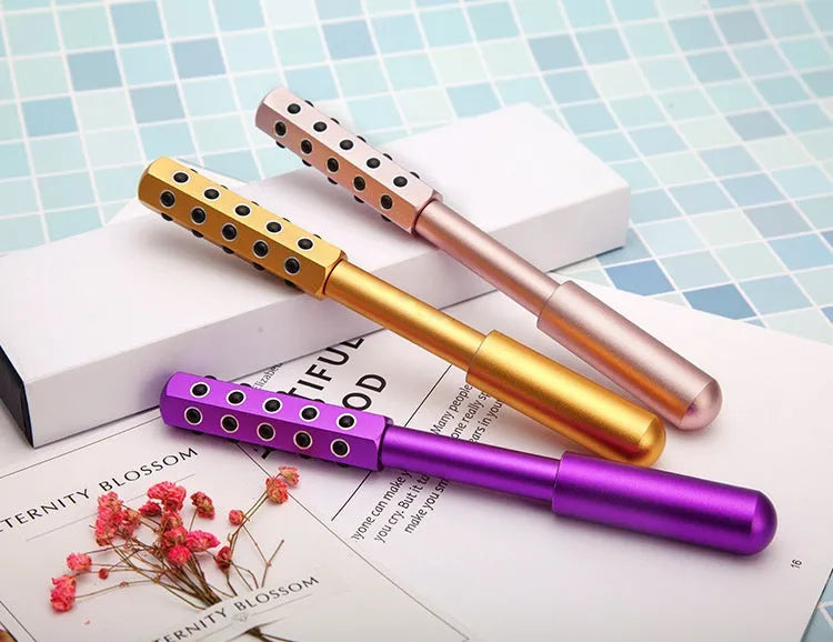 Germanium particles roller beauty massage instrument in purple colour on a white background.