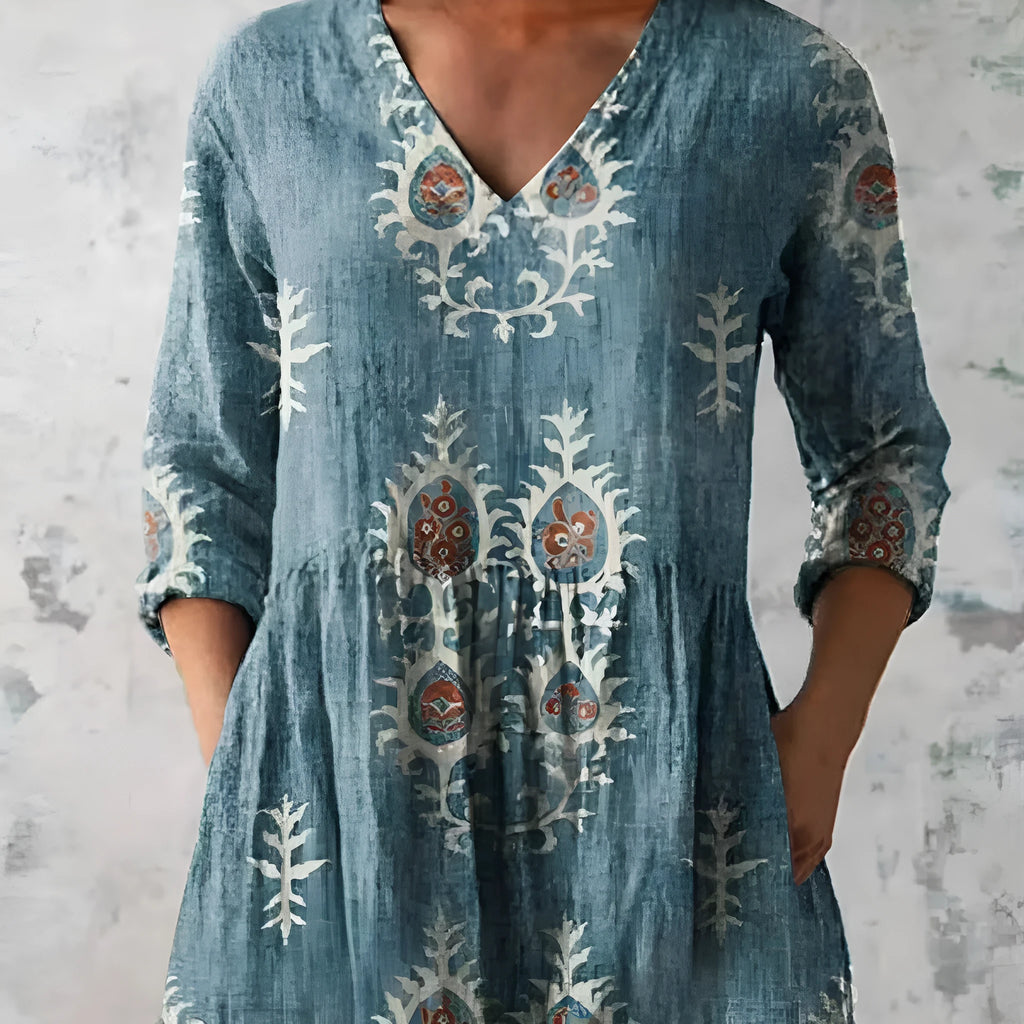 Women's printed loose wave dress with 3/4 sleeves and a wide waist on a hanger.
