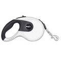 Automatic telescopic dog lead with non-slip ABS handle and stainless steel snap on green grass