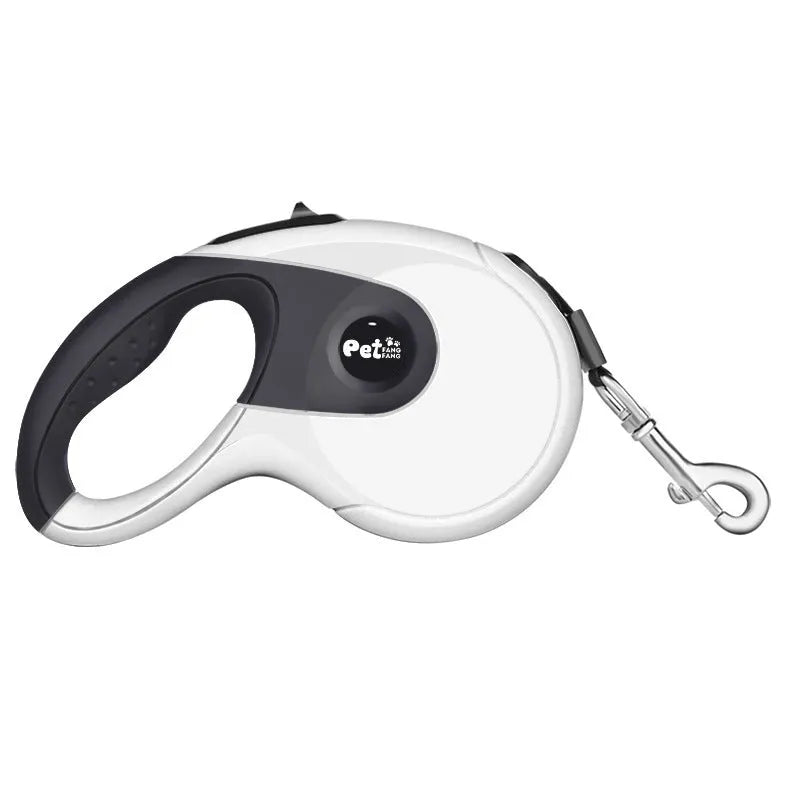 Automatic telescopic dog lead with non-slip ABS handle and stainless steel snap on green grass