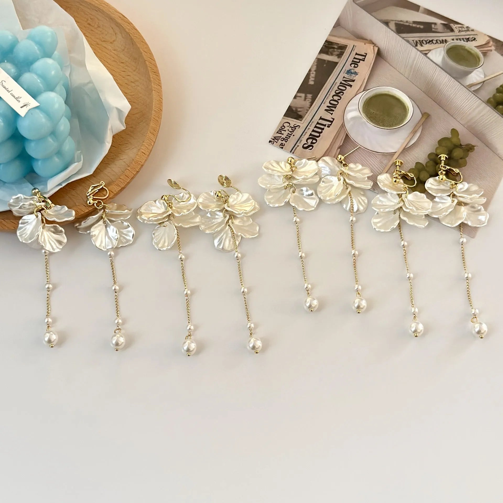 Women's shell pearl tassel earrings with acrylic construction and choice of ear clip types