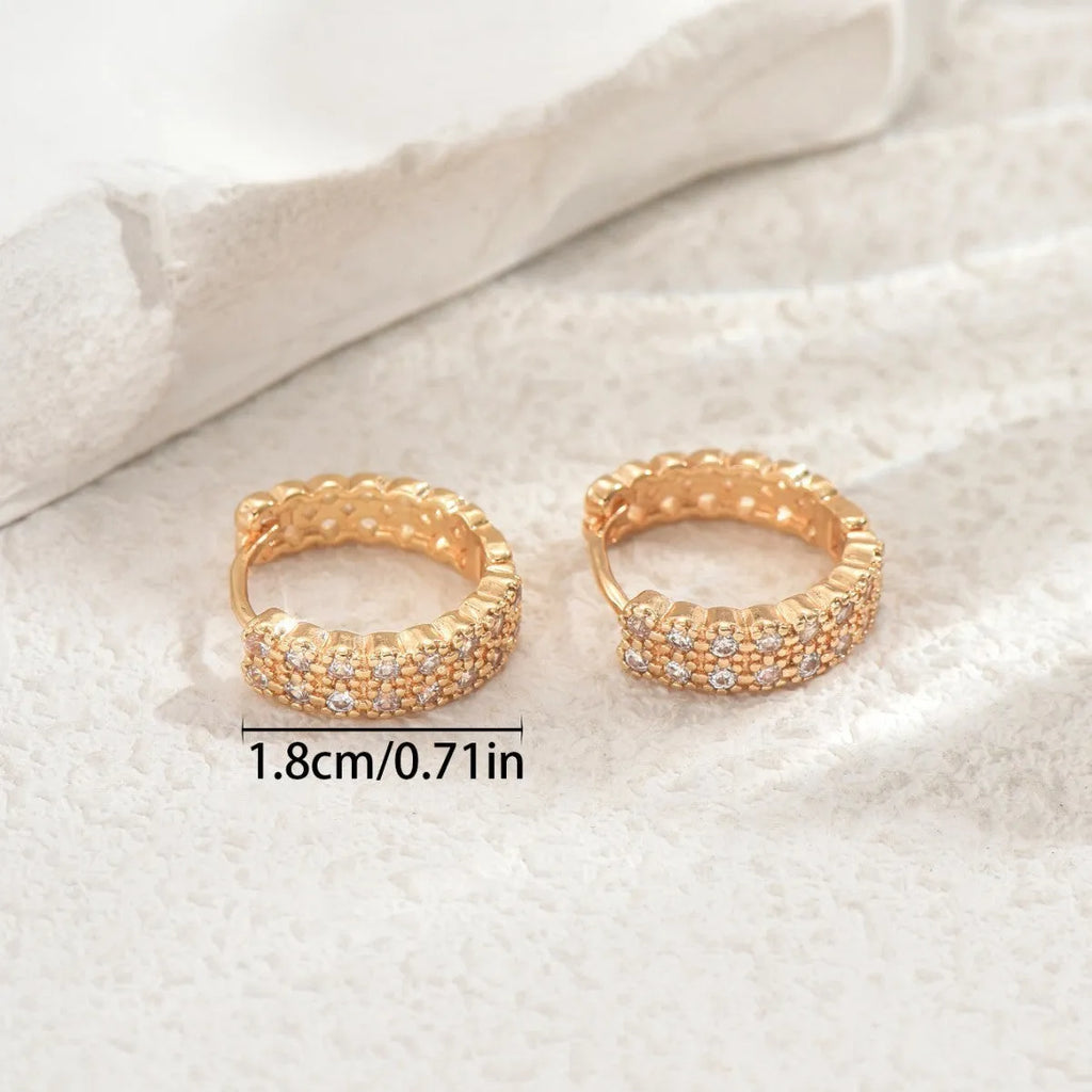 Geometric pattern copper ear studs in colour DE20288 with round, dot, and ring details.
