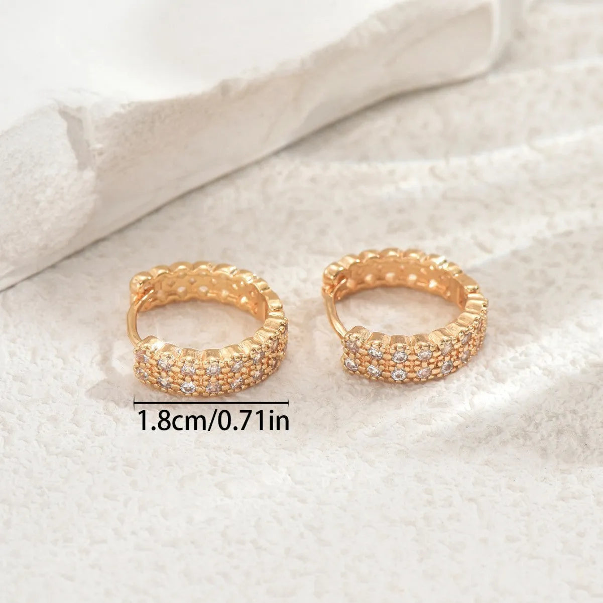 Geometric pattern copper ear studs in colour DE20288 with round, dot, and ring details.