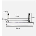 Silver stainless steel paper towel rack hanging on a kitchen cabinet door.
