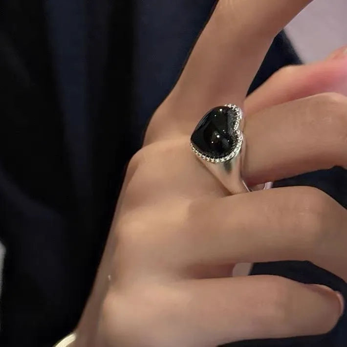 Adjustable sterling silver ring with heart-shaped black agate centrepiece showing open mouth design