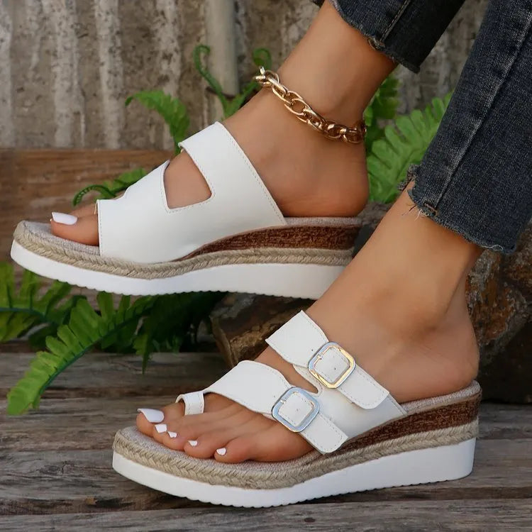 White women's wedge sandals with woven patent leather upper and peep toe.