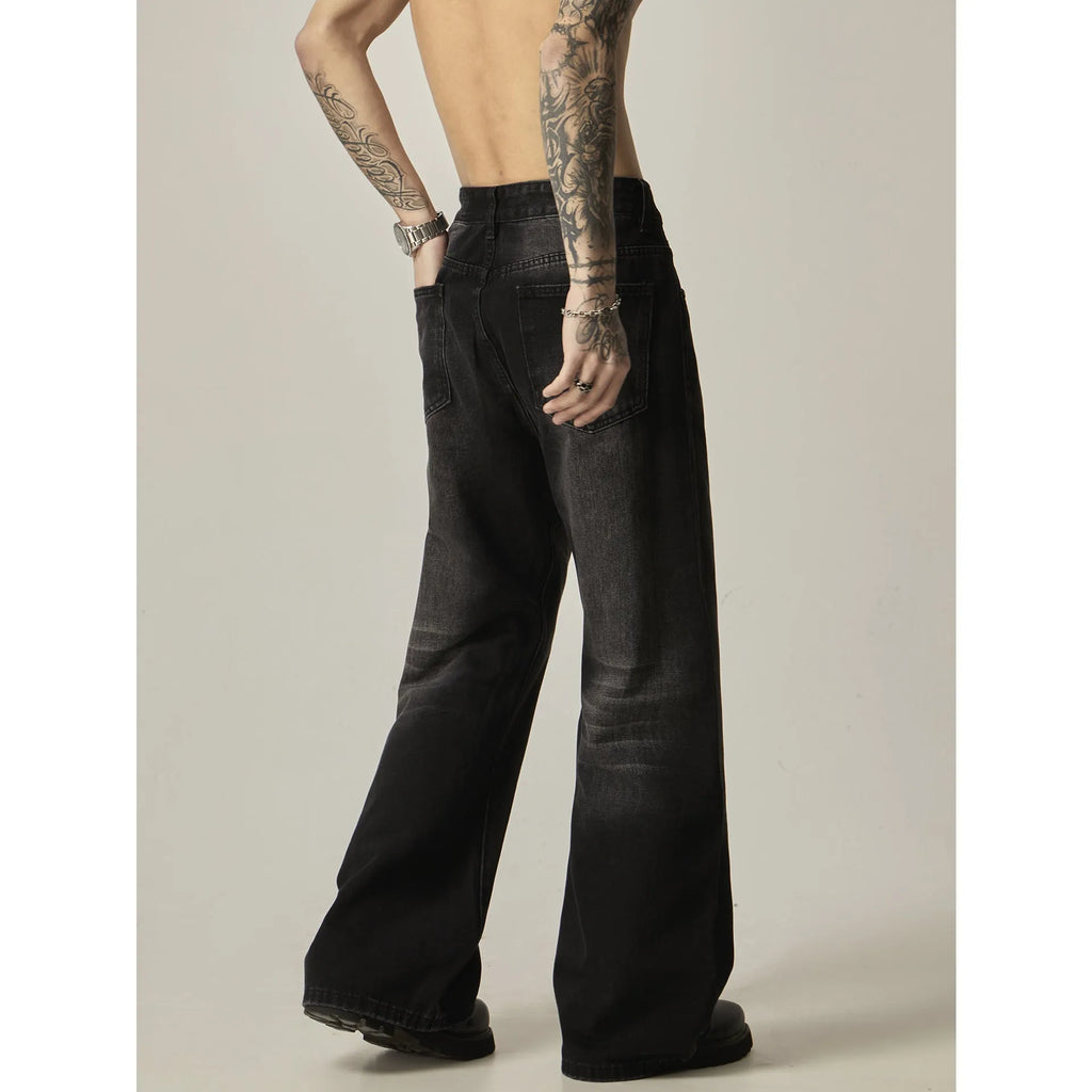 Black loose fit straight leg retro jeans on a hanger, showing zipper fly and relaxed silhouette.