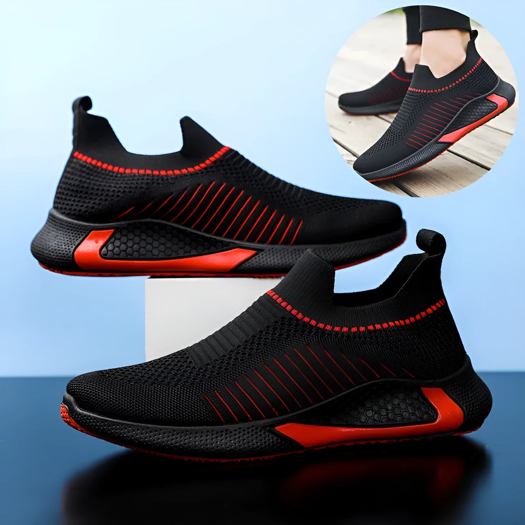 Men's black and white striped mesh slip-on sneakers with lace-up front on a plain background.