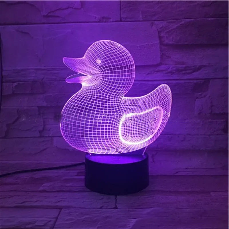 Yellow 3D duck-shaped LED night light on a table with remote control, showing multi-colour glow.