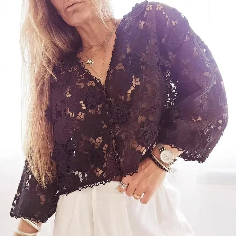 Black lace v-neck cardigan with three-dimensional white flower decorations on the sleeves.