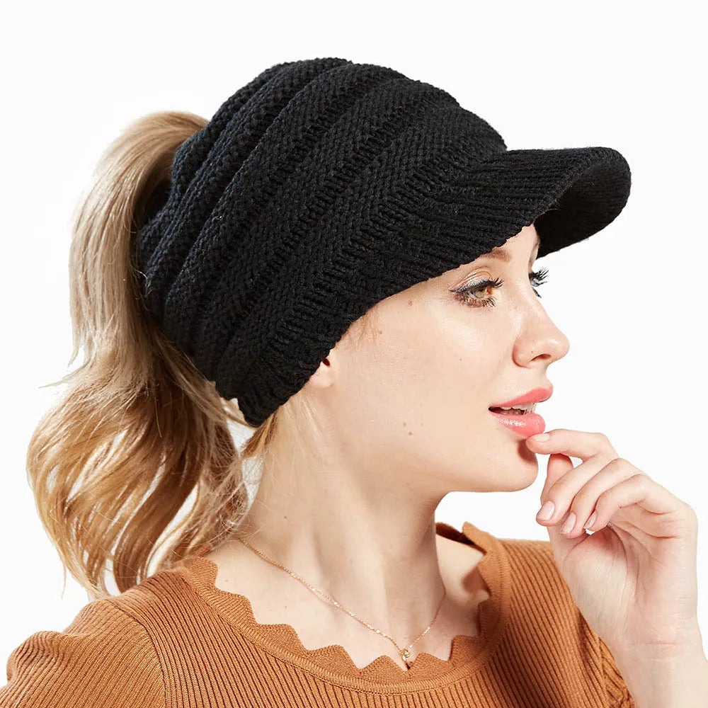 Women's soft acrylic ponytail beanie in light grey, showing the opening for a ponytail.
