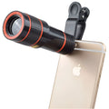 12X magnification black phone telescope lens with smartphone mounting clip on a white background.