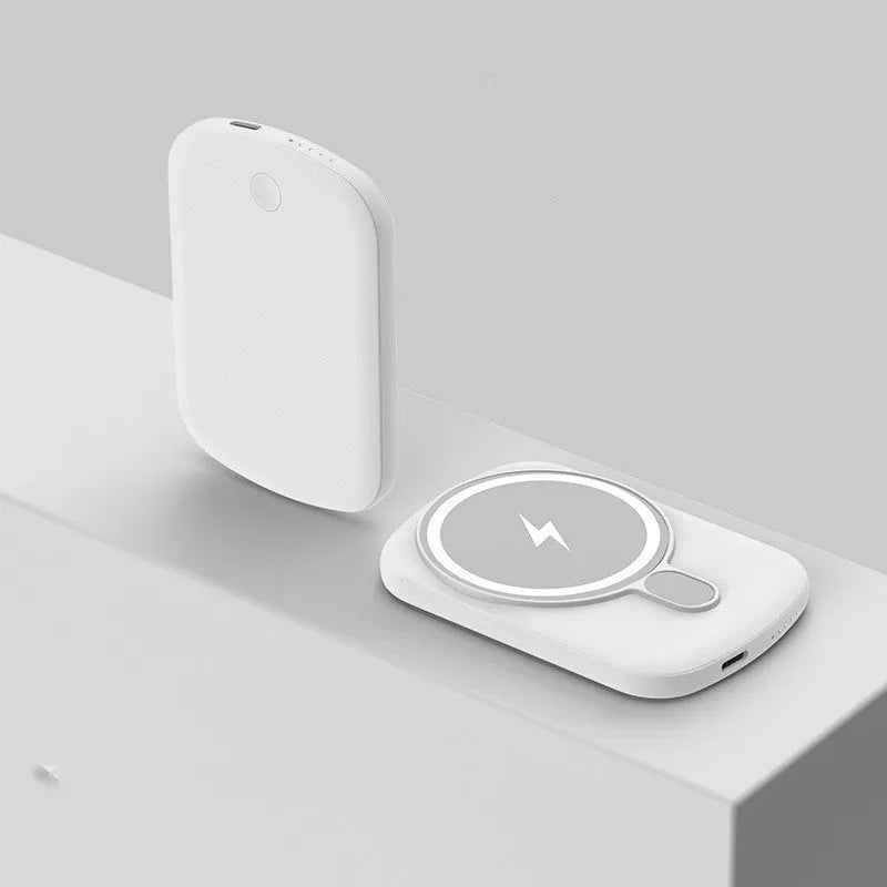 Magsafe magnetic wireless power bank in four colours: black, purple, pink, and white, next to an iPhone.