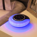 Blue cubic Bluetooth desk lamp speaker with touch controls and folding head on wooden desk