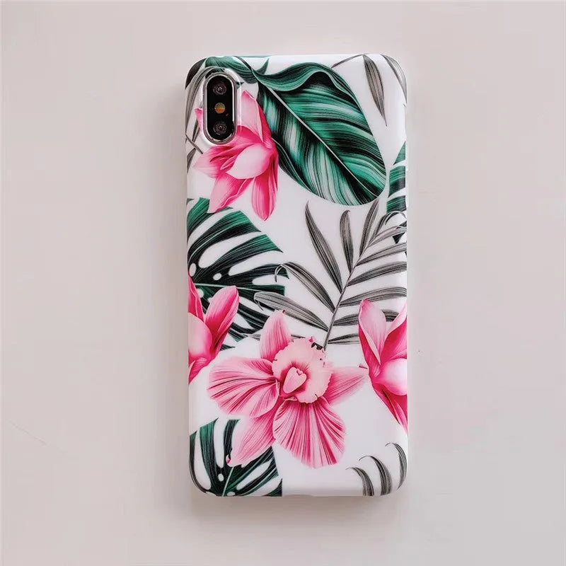 Pink floral patterned TPU back cover case for iPhone on a table.