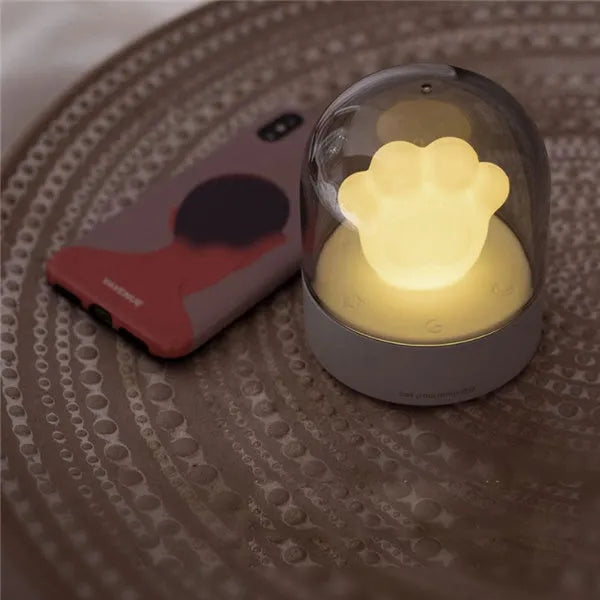 Cat paw-shaped night light with music box function showing pink colour option with illuminated soft light