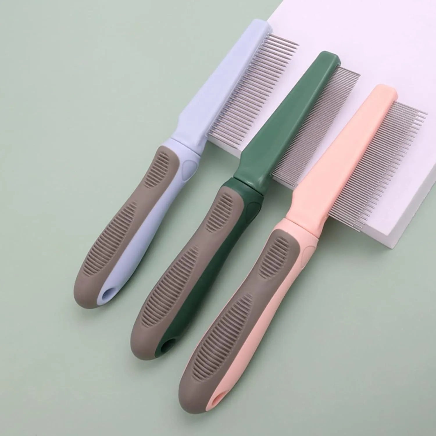 Blue pet grooming comb with three interchangeable heads: dense needle, high-low needle, and sparse needle configurations