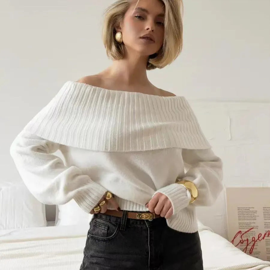 Grey off-the-shoulder sweater with a strapless neckline and a raised 3D pattern across the front.