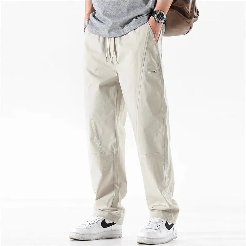 Women's milky white cotton wide-leg trousers with a straight pants-mouth opening, laid flat.