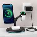Black three-in-one magnetic wireless charger for mobile phones and earbuds on a table.