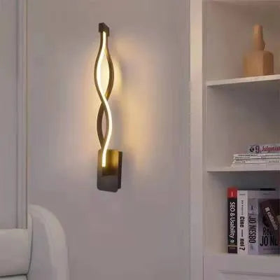 Nordic minimalist LED wall lamp with silicone shade in black finish mounted beside bed