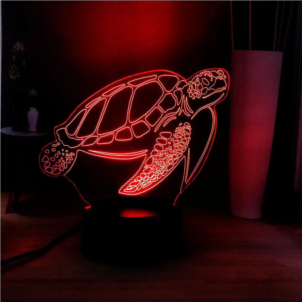 3D acrylic turtle-shaped night light glowing with multi-coloured LED light.