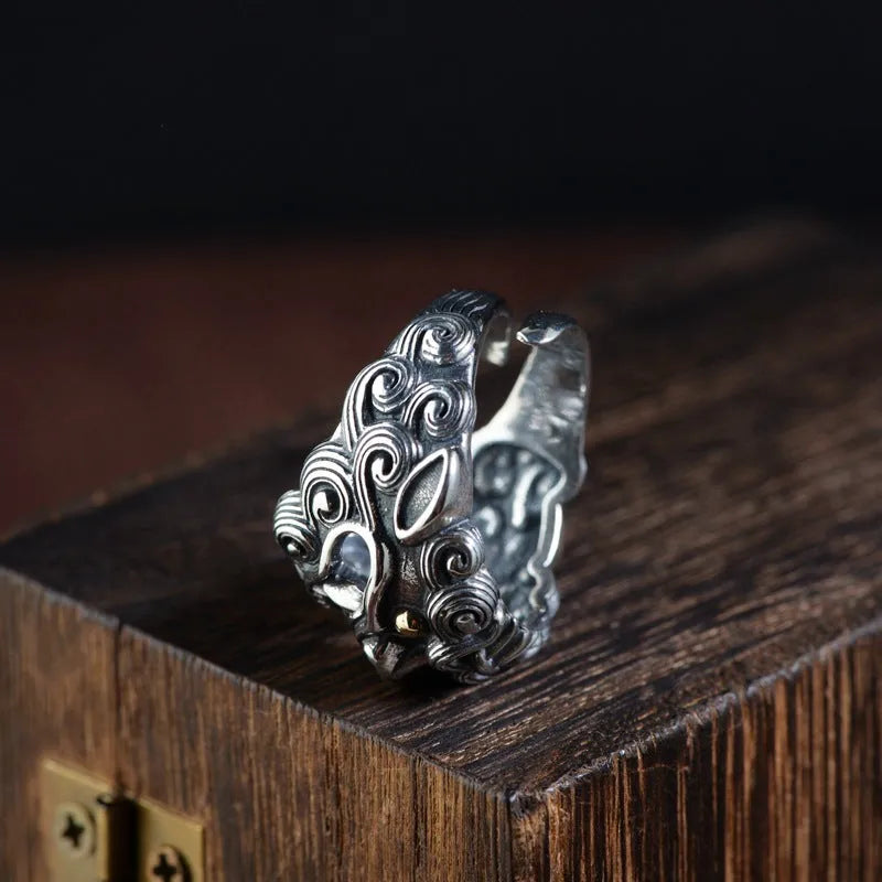 Silver open ring with a personalised diamond jibeast animal zodiac pattern on a hand.