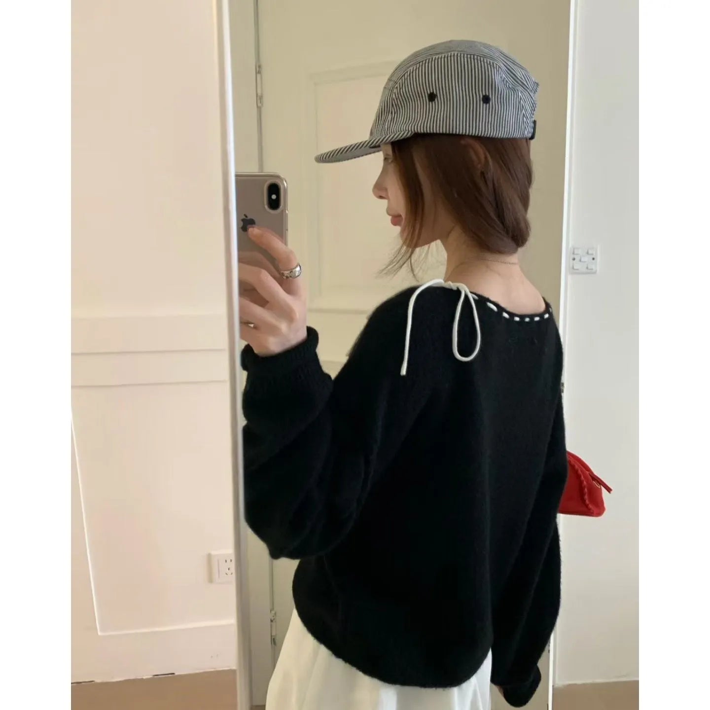 Women's loose grey knitwear pullover showing front view and relaxed fit