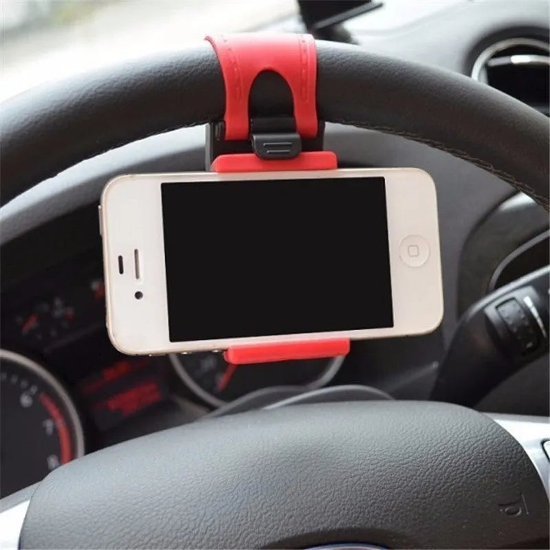 Black universal steering wheel phone holder clip mounted on a car steering wheel.