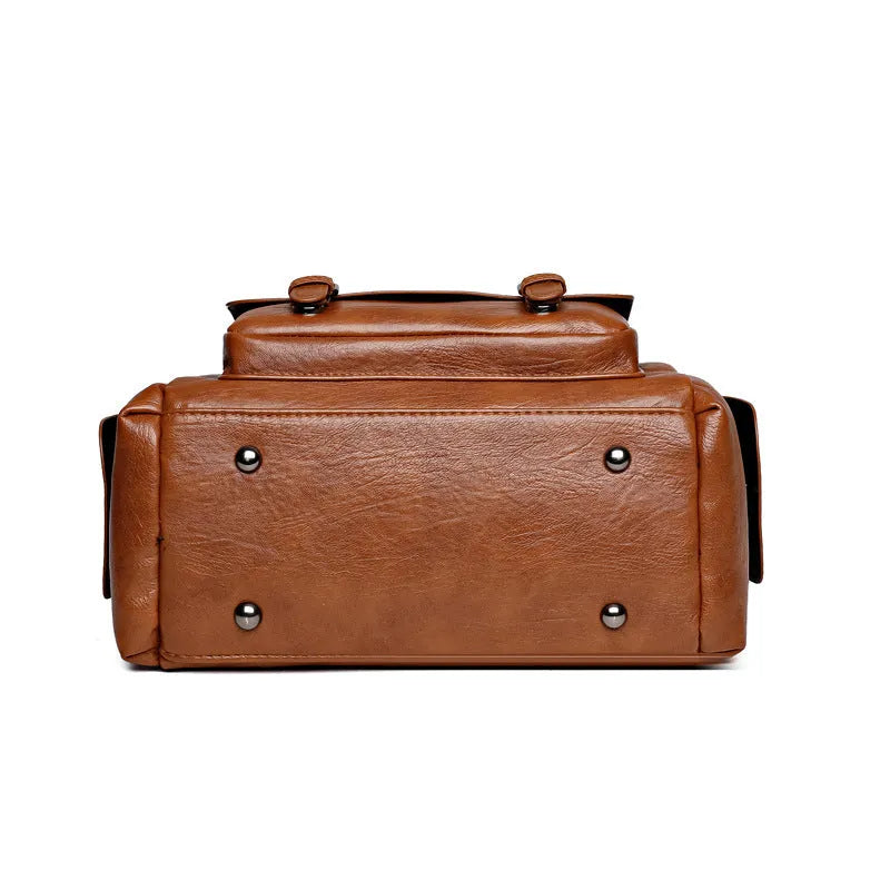Vintage style square messenger bag in PU leather with visible stitching, shown in multiple colour options.