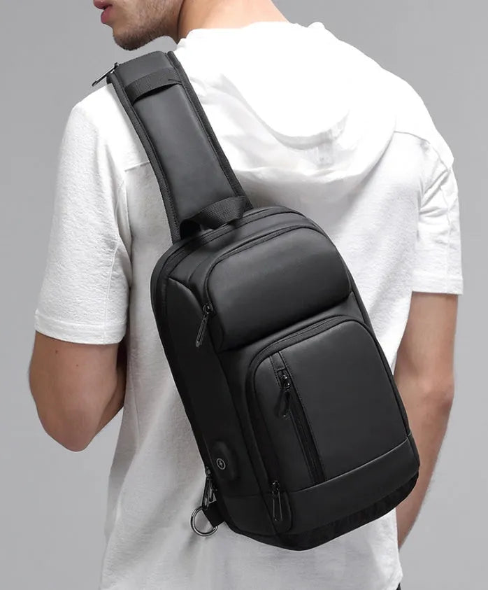 Black PVC outdoor shoulder bag with air cushion strap, soft handle, and laptop compartment