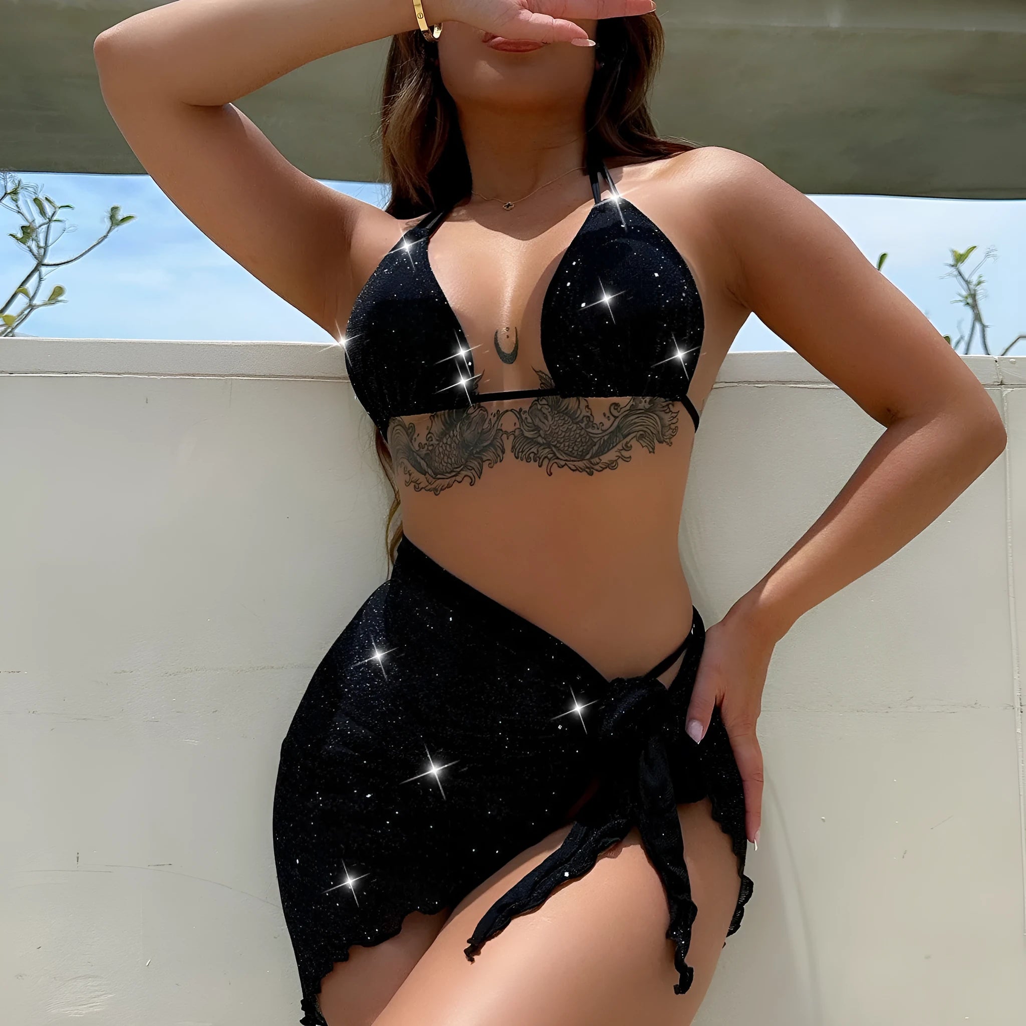 Black women's three-piece bikini swimsuit set consisting of a top and shorts on a mannequin.