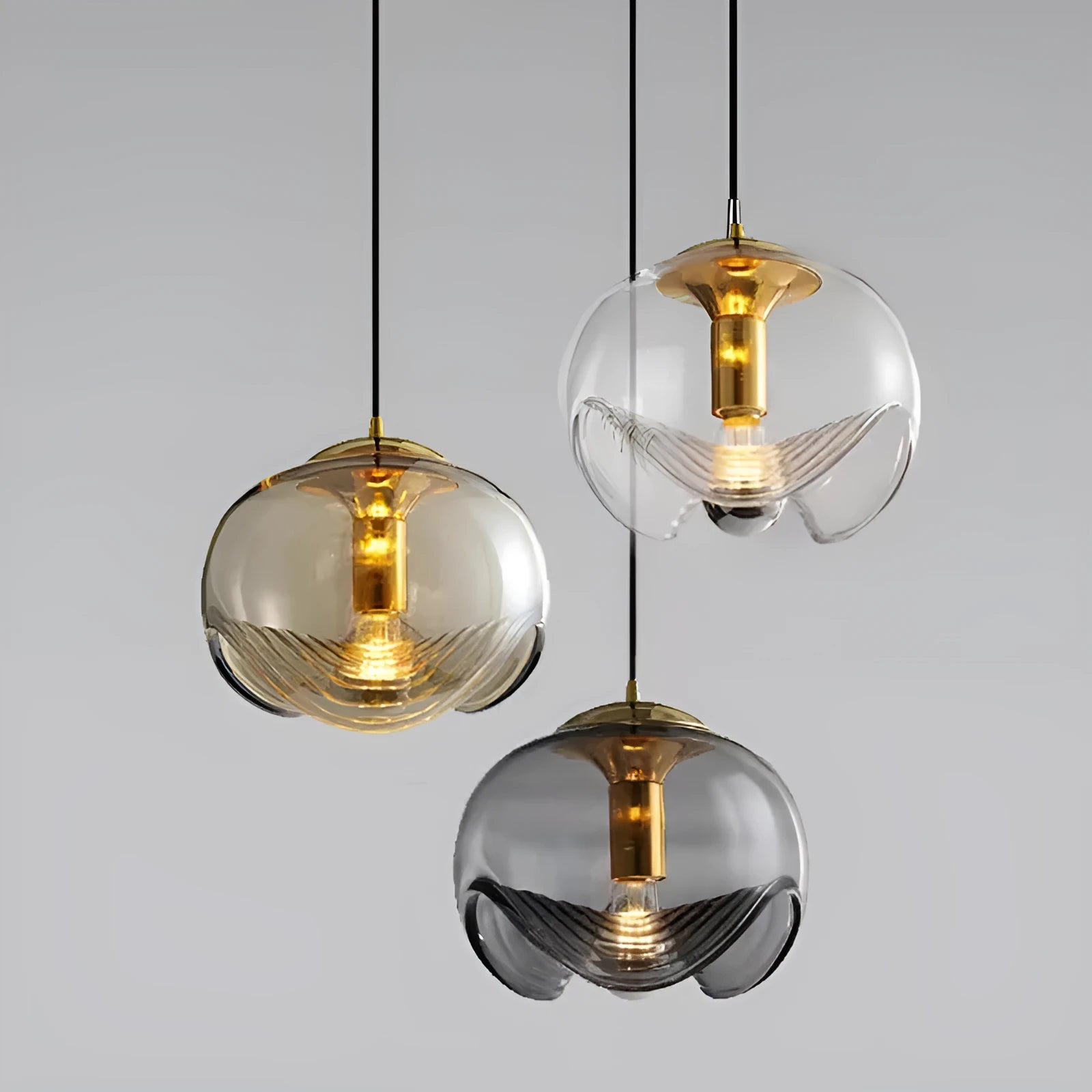 Modern minimalist glass chandelier with 25cm diameter, shown in transparent, amber, or smoky gray colour options.