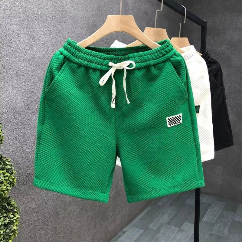 Solid colour polyester sports shorts with elastic waist on a mannequin, shown in black.