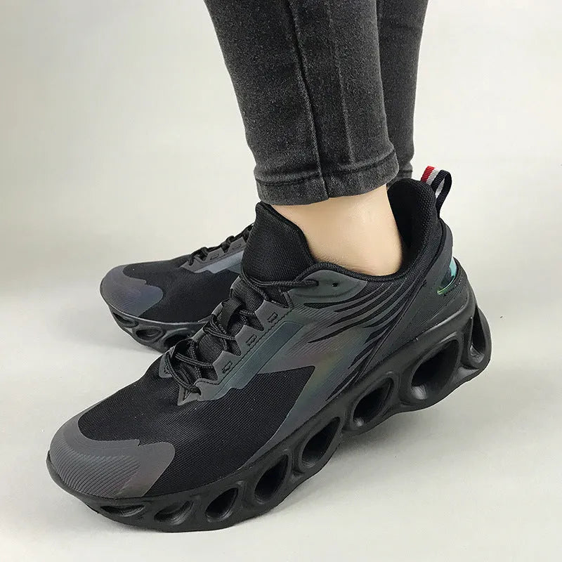 Men's low top casual shoes in black with mesh upper and white lace-up closure.