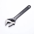 High-carbon steel adjustable spanner with black finish on a grey background.