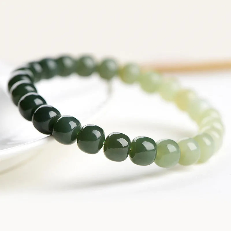Natural Hetian jade bracelet with water gradient colours on wrist.